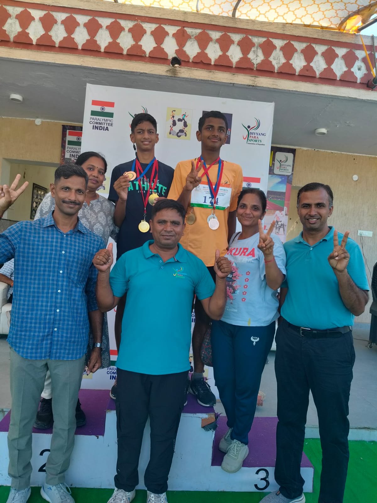 Indian sports coach guiding a young athlete in positive movement exercises